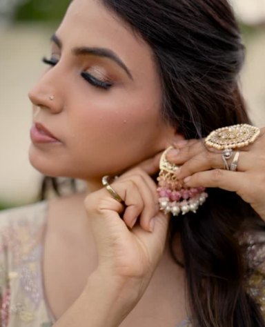 Close-up of jhumka and statement ring with pastel outfit